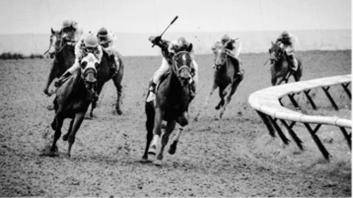 6 jockeys riding horses on a race track in black and white