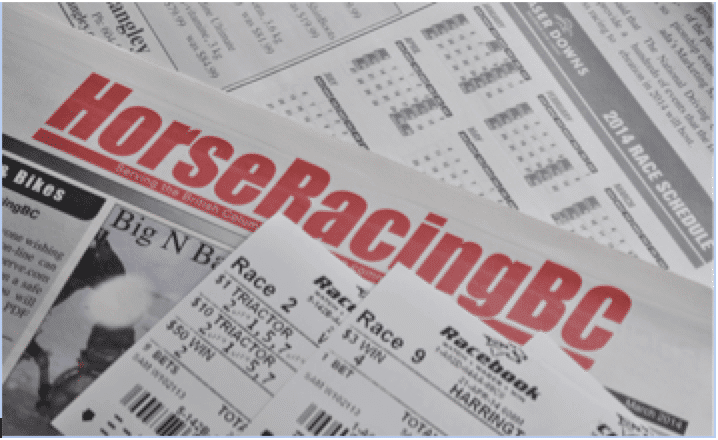 1horse racing tips on a newspaper with two tickets for the races in close up